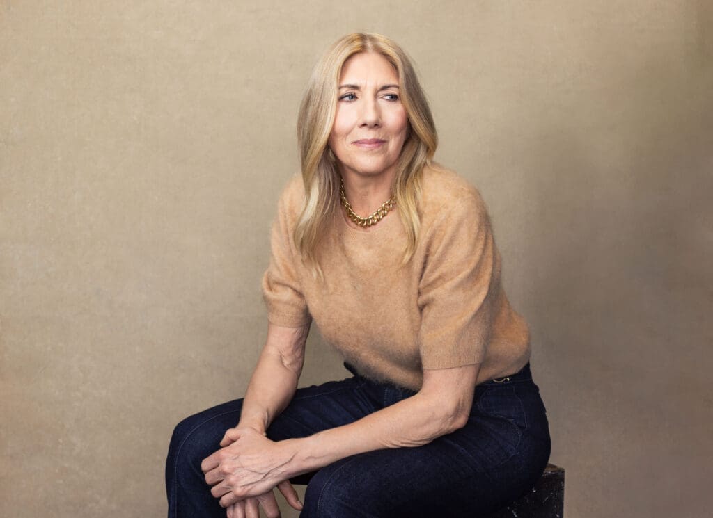Editorial style portrait of Shelly Wight seated in a tan sweater looking off camera during a Cincinnati Ohio personal branding session.
